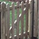 10 meters of round topped, 75mm wide pales sat on top of a gravelboard. Access into the garden was through a small 900mm x 900mm wide garden gate.