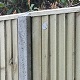 15m of 1.8m x 1.5m weatherboard panels sat on a 300mm x 1.8m wide concrete gravel board, and supported by 2.4m concrete slotted posts.