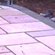 20m² of Chantry Woodland natural sandstone paving laid at two levels, edged with a Blue enginerring brick on edge.